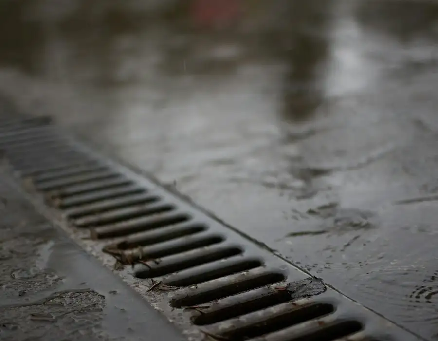 Metal drain grate on wet concrete